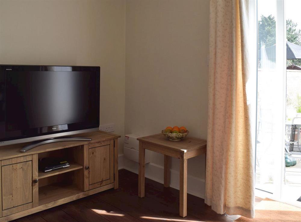 Living room with TV at The Coastal Cottage in Kessingland, Suffolk, England