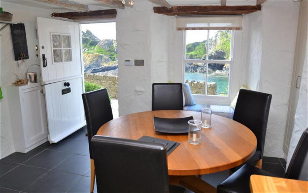 The dining area in the kitchen with lovely views of the harbour at The Cobbles in Polperro
