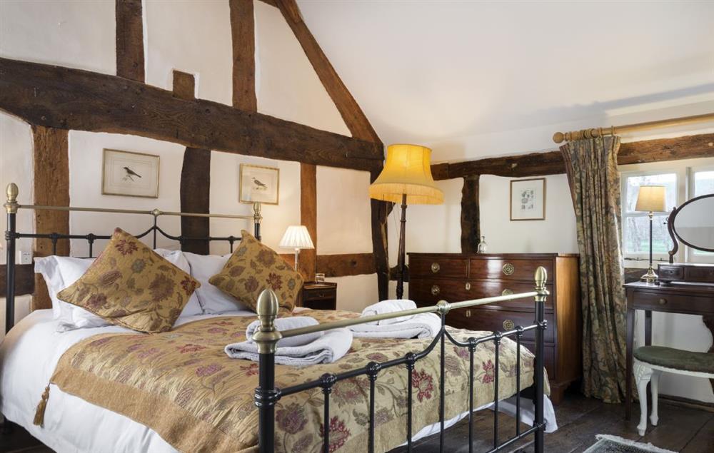 Master double bedroom with king size 5’ bed and exposed beams at The Coppice, Ashton under Hill