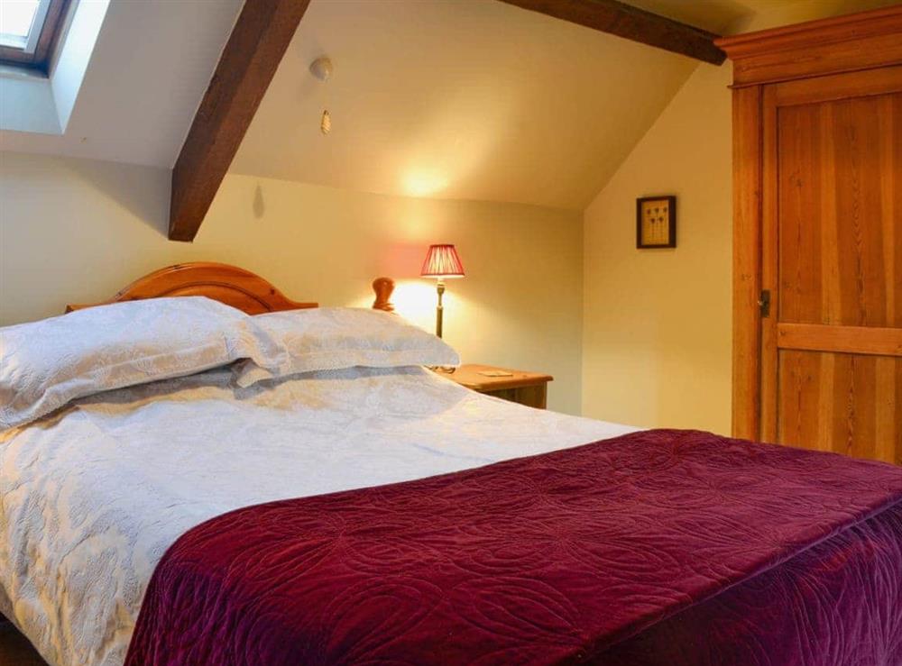Cosy and romantic double bedroom with beamed ceiling at The Cot in Bussage, near Cirencester, Gloucestershire