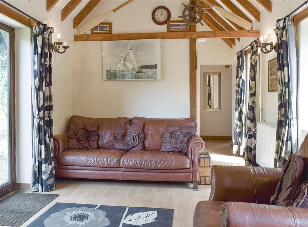 Characterful living room with exposed wood beams at The Cotes in Upper Welland, near Malvern, Worcestershire
