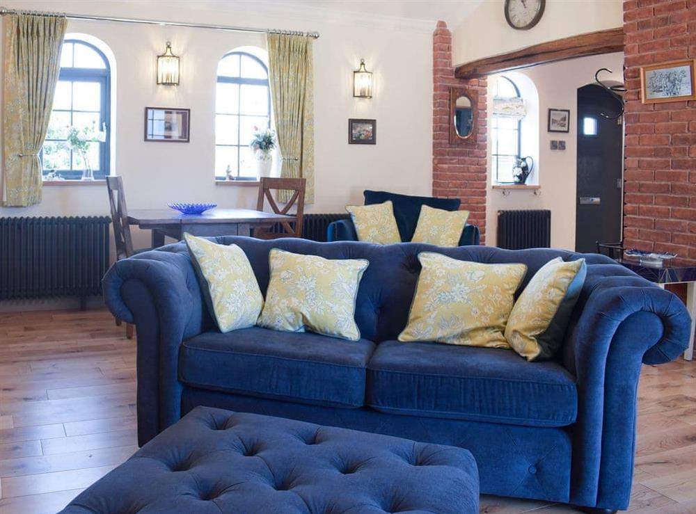 Comfortable living area with intimate dining area at The Cottage At Broad Lake in Marchamley, near Shrewsbury, Shropshire
