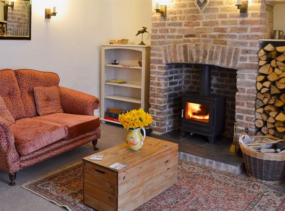 Comfortable living room with wood burner at The Cottage in Broadstairs, Kent, England