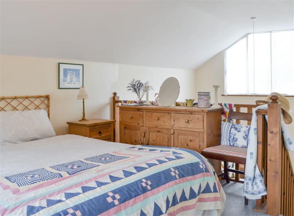 Relaxing double bedroom on mezzanine at The Cottage Island Heron in Wolverton Common, near Tadley, Hampshire