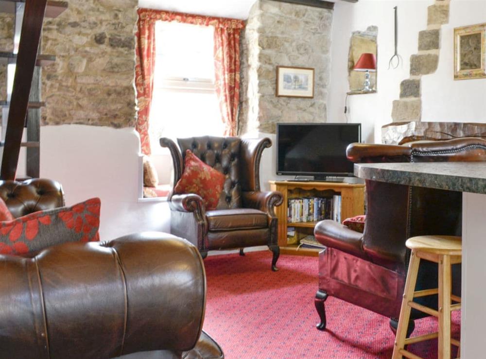 Characterful living area with open fire at The Cottage in Linton, near Grassington, North Yorkshire
