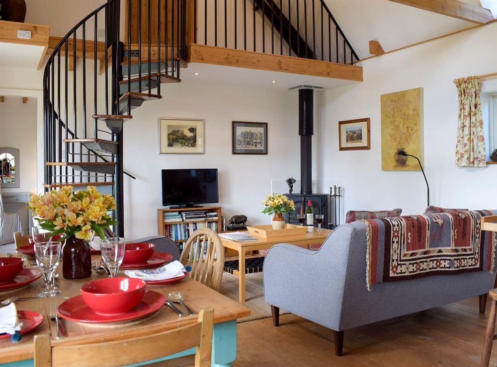 Open plan living space with wooden floor at The Cottage in Richards Castle, near Ludlow, Shropshire