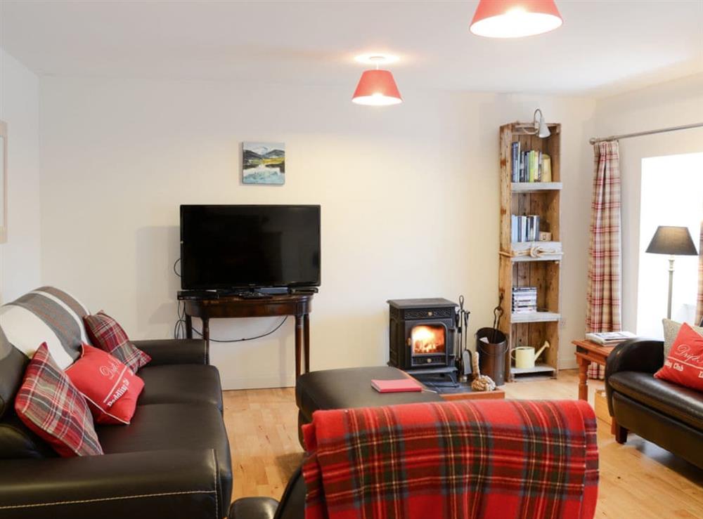 Spacious open plan living area with doublr sofa bed and wood burner at The Cottage in Rispond, near Durness, Northern Highlands, Sutherland