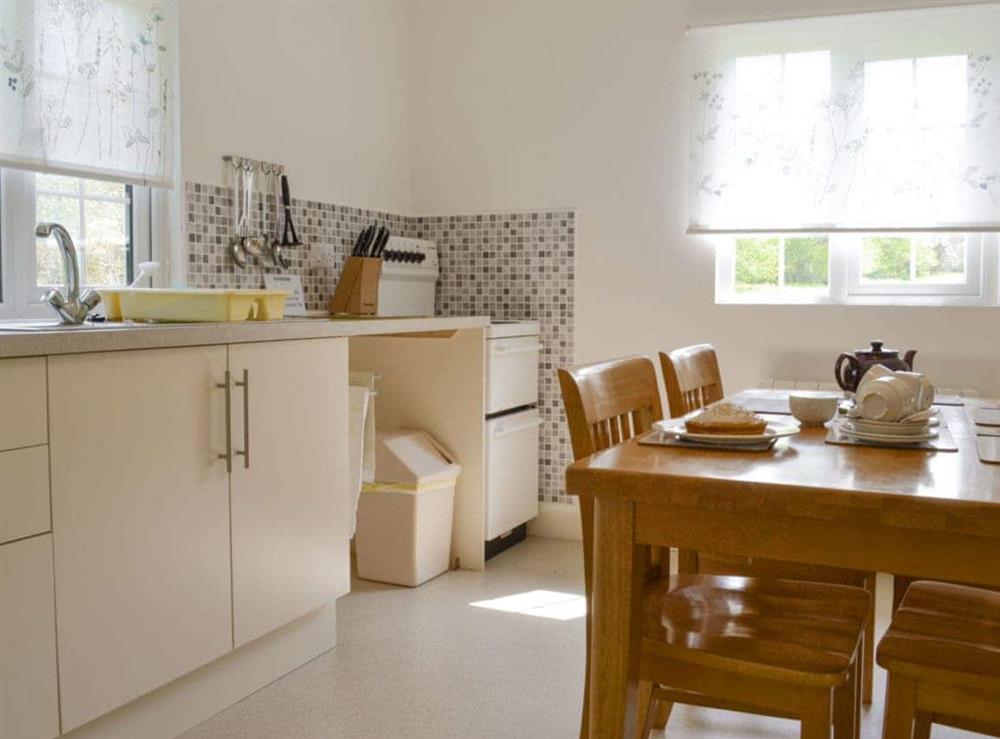 Well-equipped fitted kitchen with dining area at The Cottage in Scarning, near Dereham, Norfolk