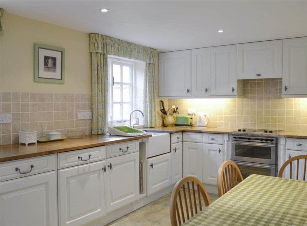 Well-equipped fitted kitchen with dining area at The Cottage in Sinnington, near Pickering, North Yorkshire