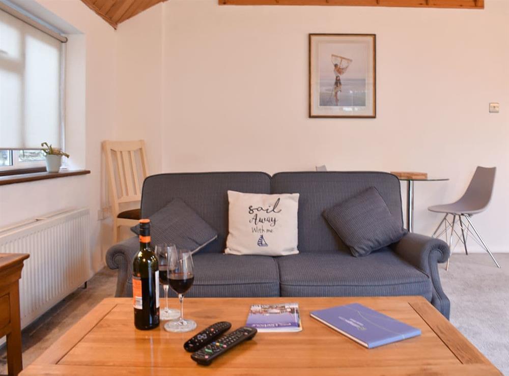 Comfortable living room with dining table at The Cottage By The Sea Annexe, 