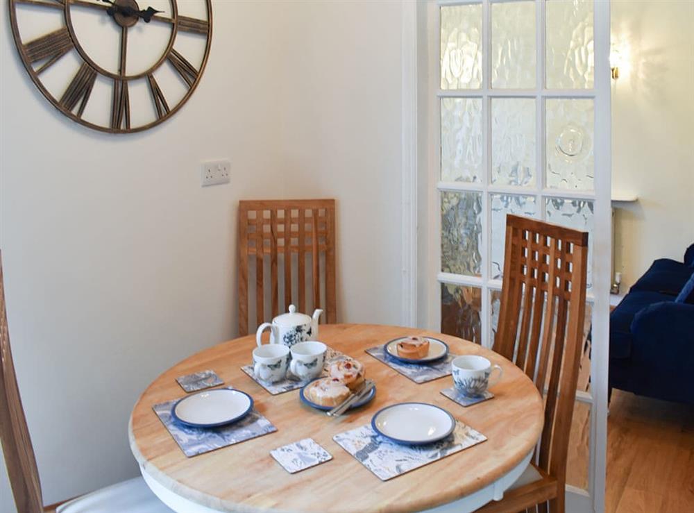 Compact dining area with double doors from the living room at The Cottage by the Sea, 