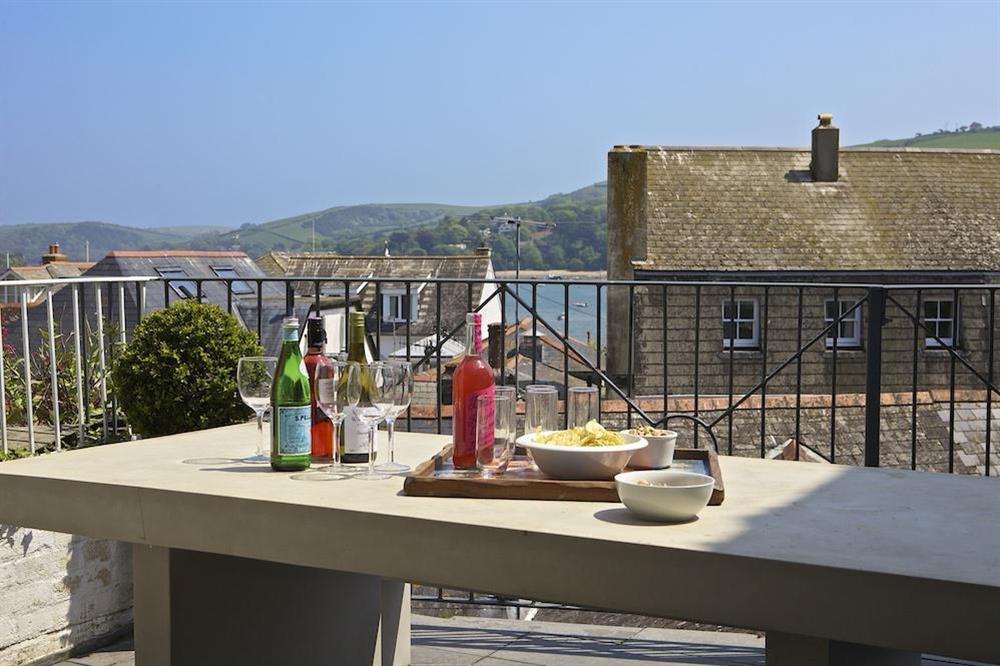 Terrace area extending out from the kitchen with glimpses of the estuary at The Court House in Buckley Street, Salcombe