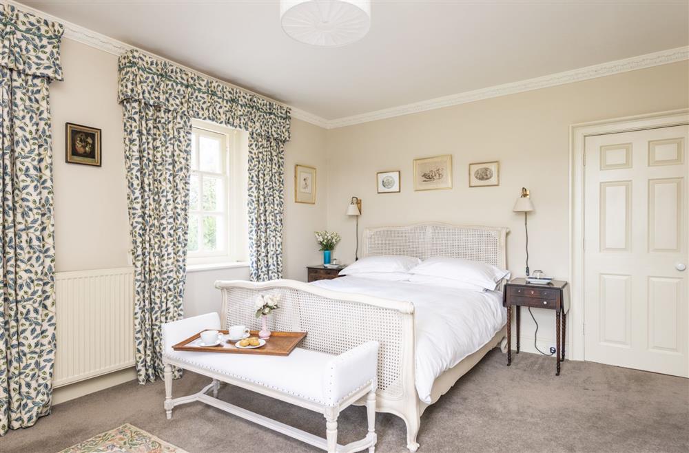 Bedroom two with  5’ king-size bed and en-suite bathroom at The Courtyard House, Winterborne Came