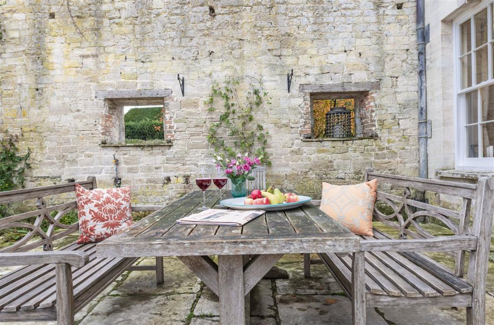 Enjoy the courtyard garden with bench seating  at The Courtyard House, Winterborne Came