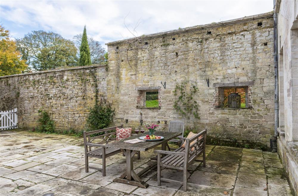 The characterful courtyard with garden furniture at The Courtyard House, Winterborne Came