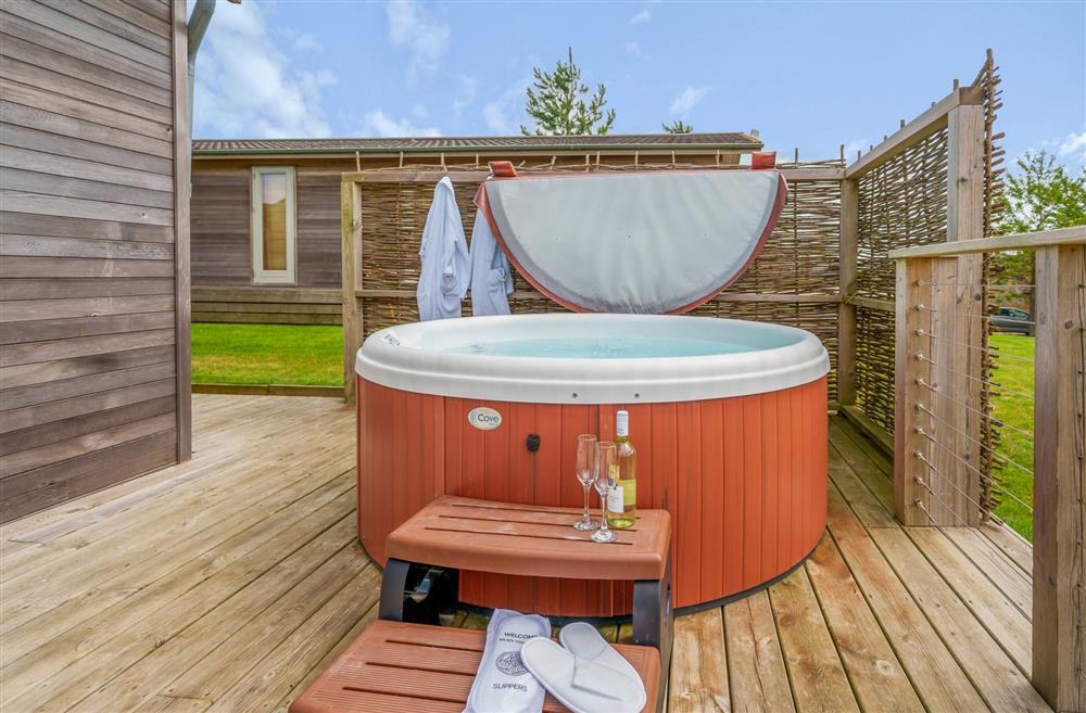 Enjoy countryside views from the hot tub on the sun deck at The Cow Shed, Sherborne