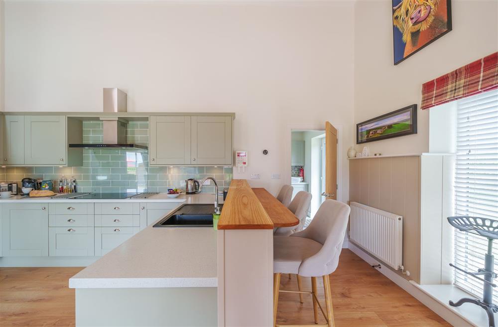The kitchen area with access to the utility room at The Cow Shed, Sherborne