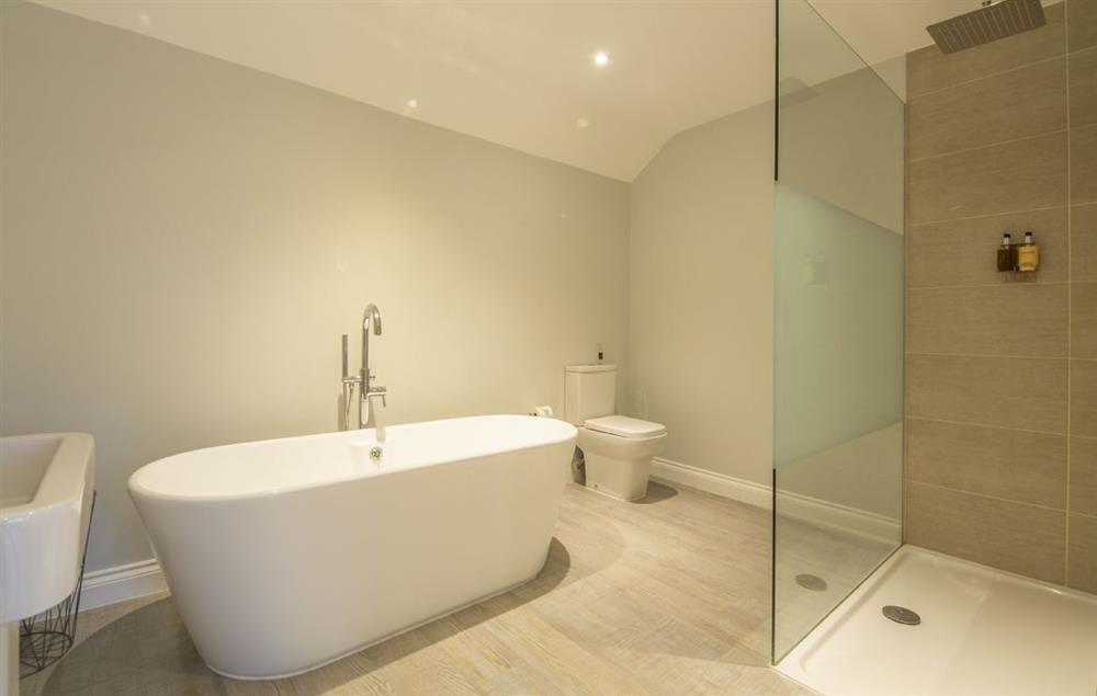 Bathroom with free standing bath and separate walk-in rainfall shower at The Cowshed at Green Valley Farm, Ubbeston