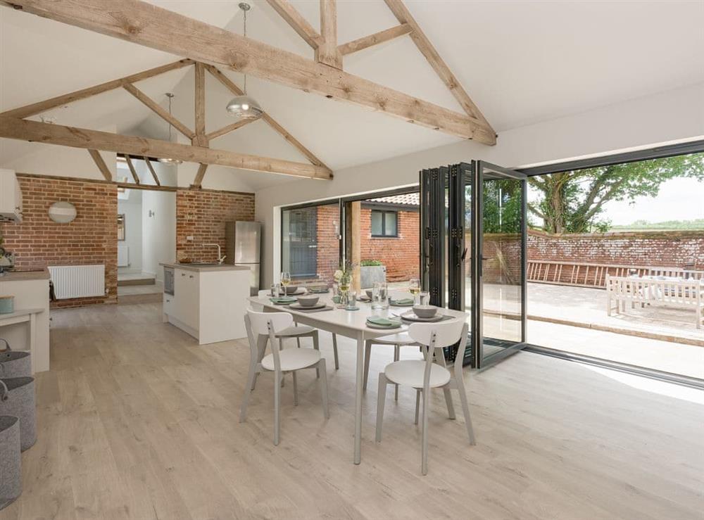 Contemporary living space with bi-fold doors at The Cowshed in Reepham, Norfolk