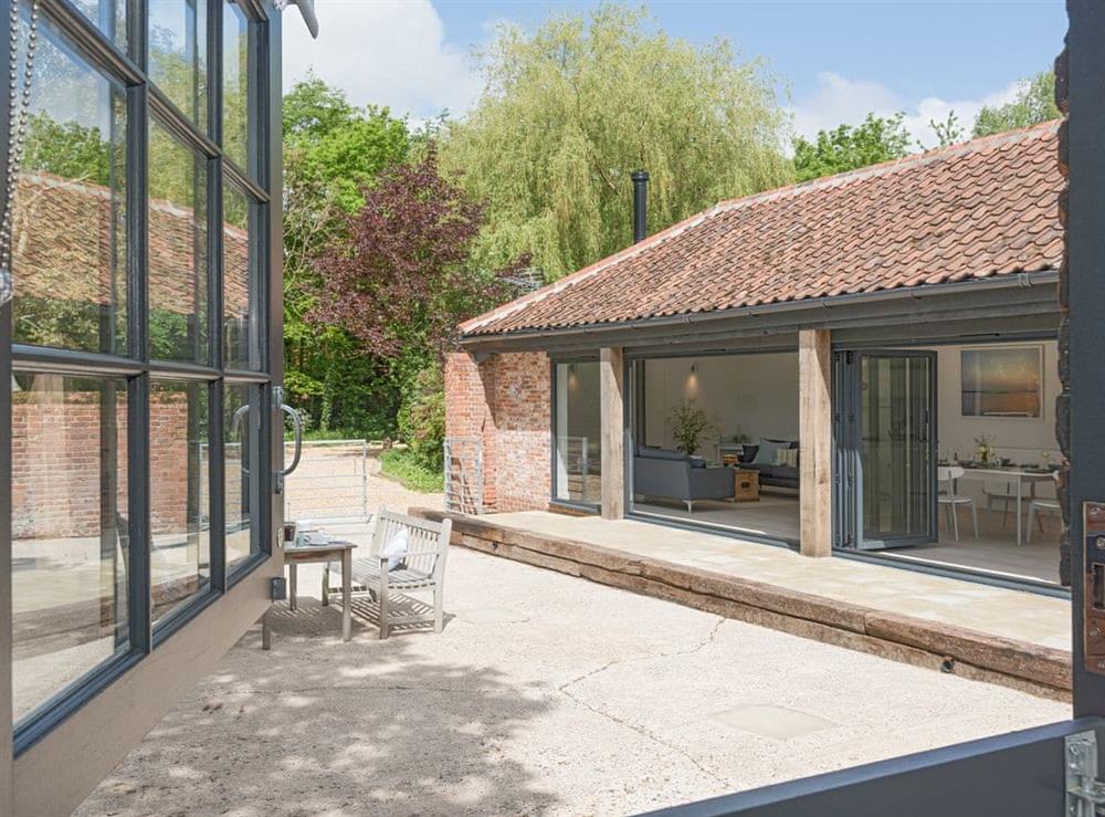 View from double bedroom to enclosed patio at The Cowshed in Reepham, Norfolk