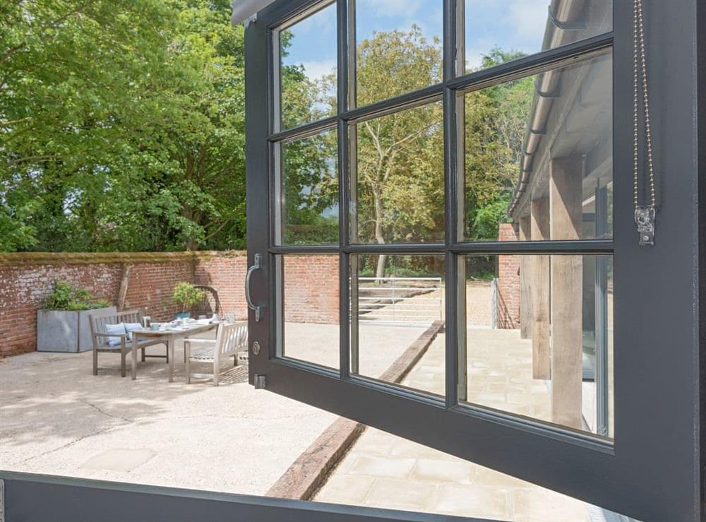 View from second double bedroom to enclosed patio at The Cowshed in Reepham, Norfolk
