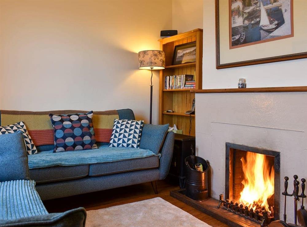 Cosy living room with open fire at The Creagan in Corrie, near Brodick, Isle Of Arran