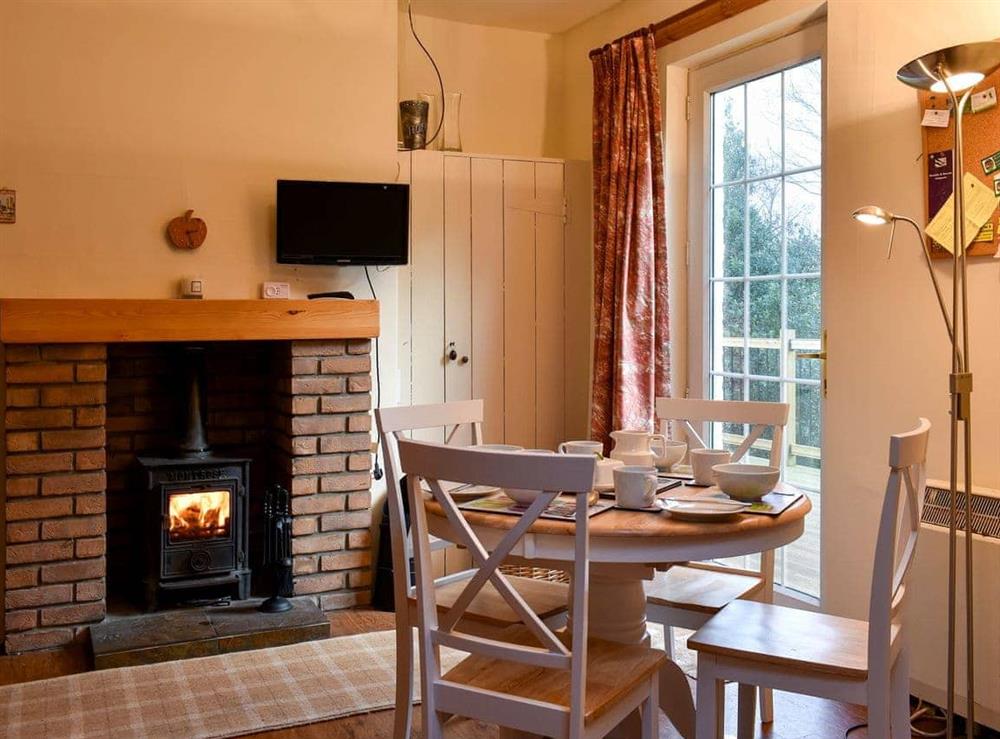 Dining area with wood burner at The Creagan in Corrie, near Brodick, Isle Of Arran