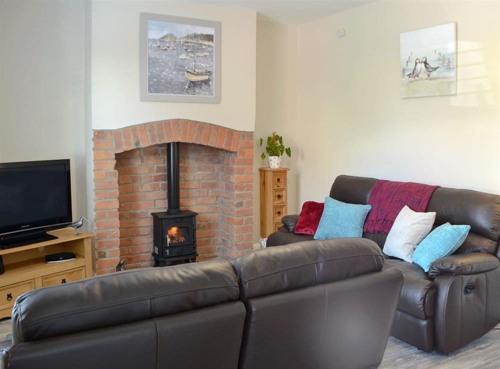 Comfortable sitting room with wood burner at The Creel House in Amble, Northumberland