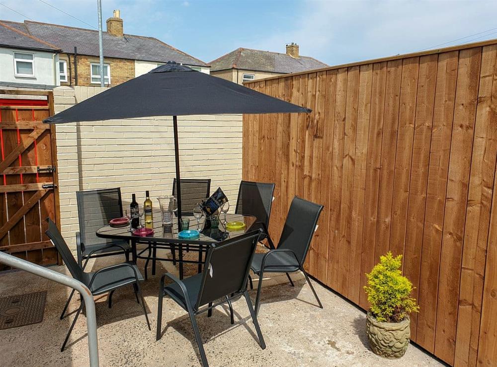 Enclosed rear yard with garden furniture at The Creel House in Amble, Northumberland