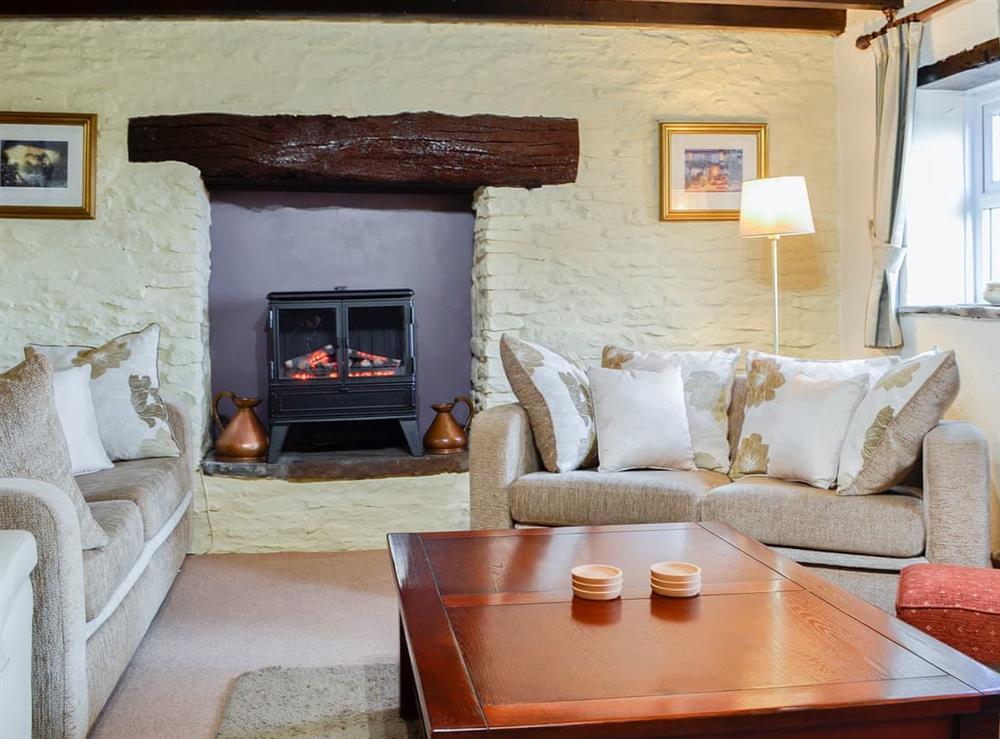 Lovely and cosy living room with feature fireplace at Penny Croft, 