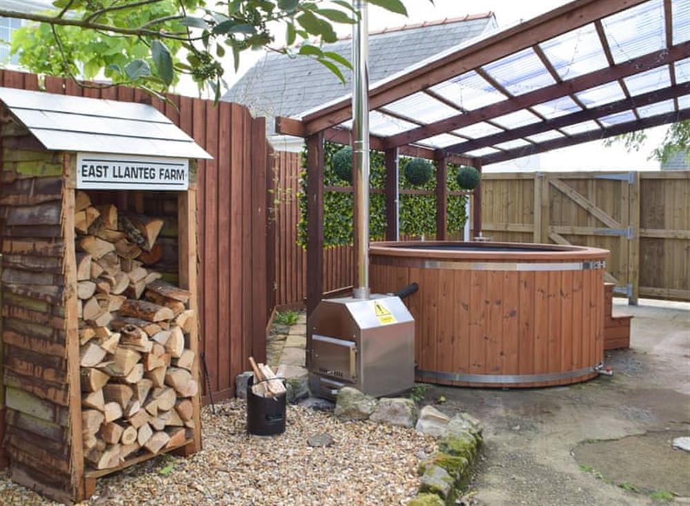 Outdoor area with wood-fired hot tub at The Cwtch in Llanteg, near Amroth, Dyfed