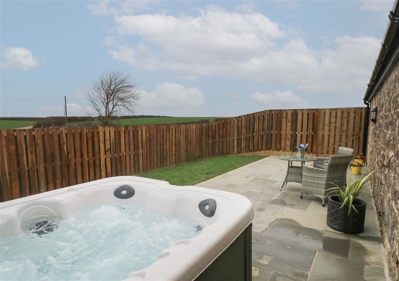 Relax in the hot tub at The Cwtch, St Brides Major