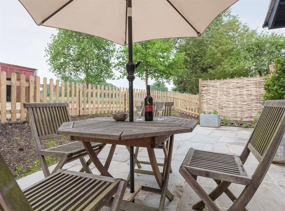 Spacious patio area at rear of property at The Dairy in Beauworth, near Alresford, Hampshire