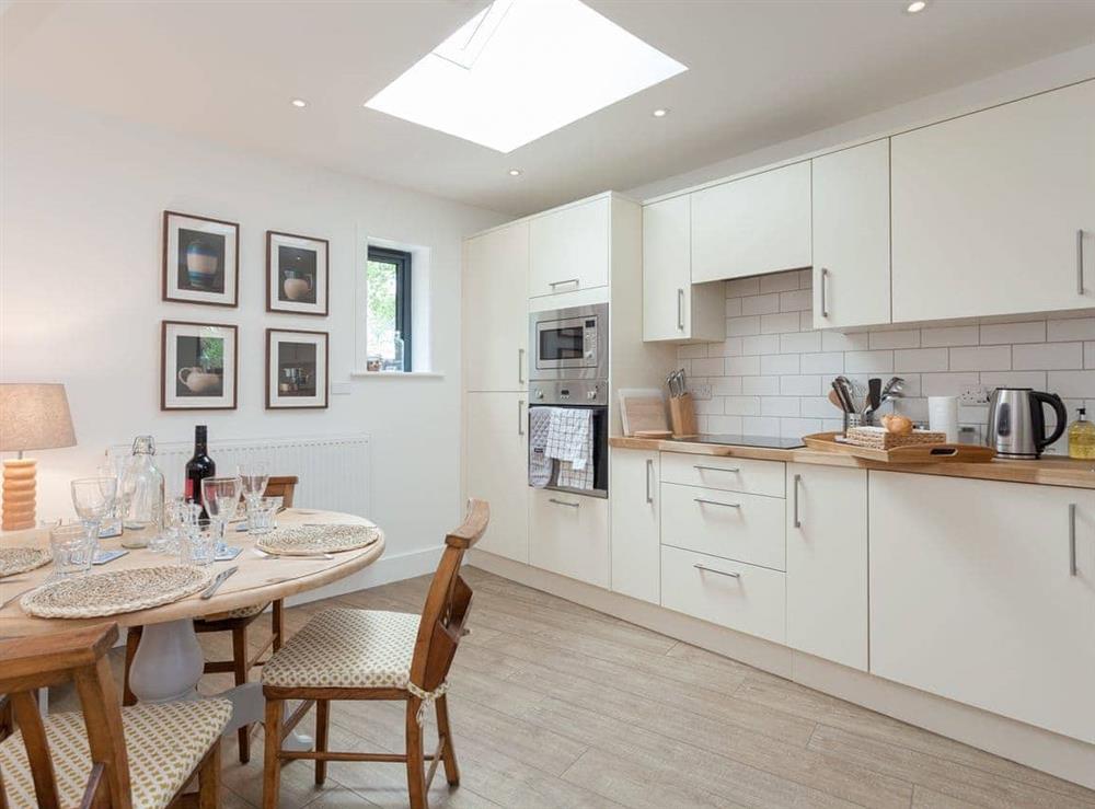 Well-equipped fitted kitchen with dining area at The Dairy in Beauworth, near Alresford, Hampshire