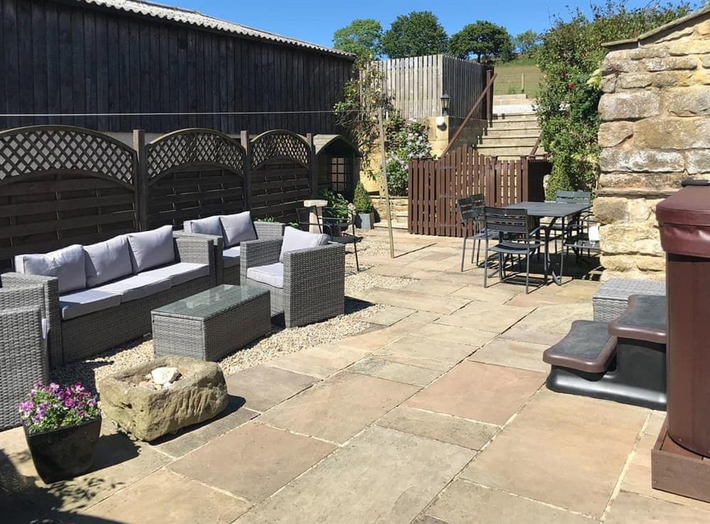 Attractive courtyard with hot tub and outdoor furniture at The Dairy in Beck Hole, near Goathland, North Yorkshire