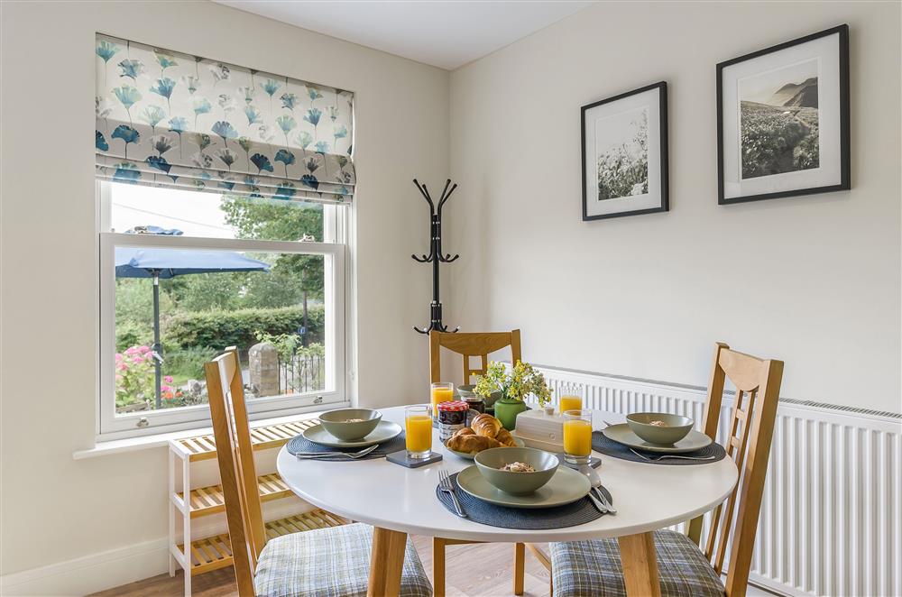 The dining area has a view of the garden and countryside beyond at The Dairy, Braunton 
