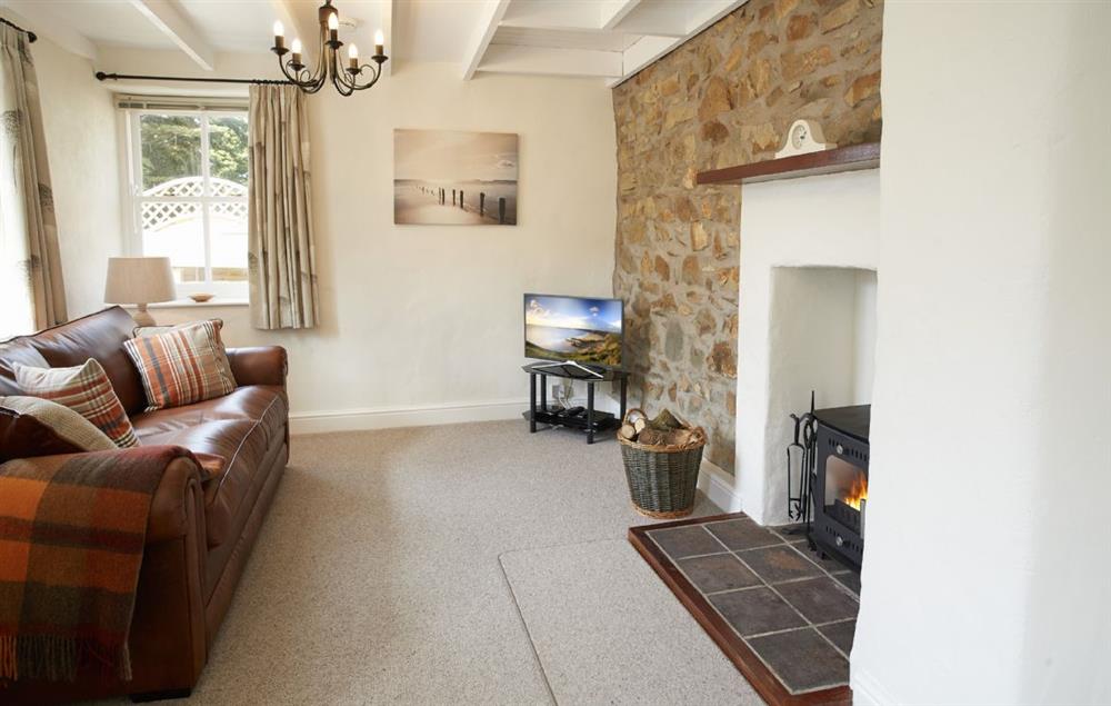 Cosy sitting room with wood burning stove at The Dairy, Dinas Cross