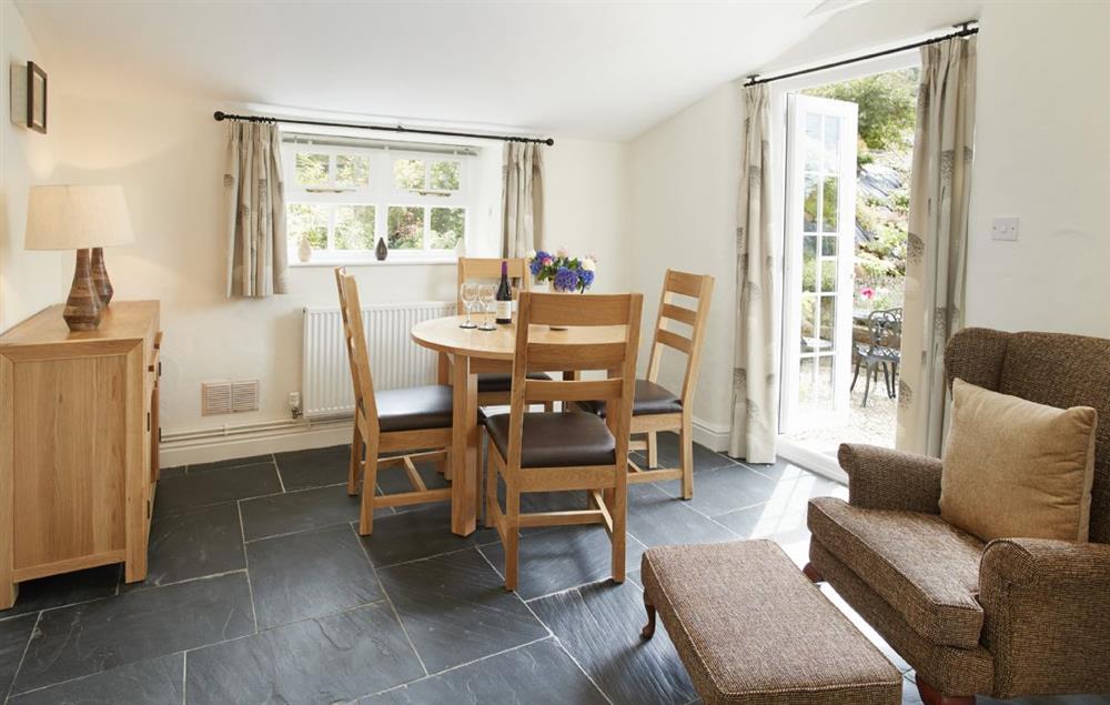 Dining room with french doors leading to the courtyard garden at The Dairy, Dinas Cross