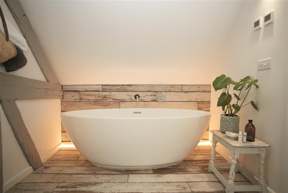 The romantic, back-lit bath in a cosy alcove of the bedroom at The Dairy, Eckington