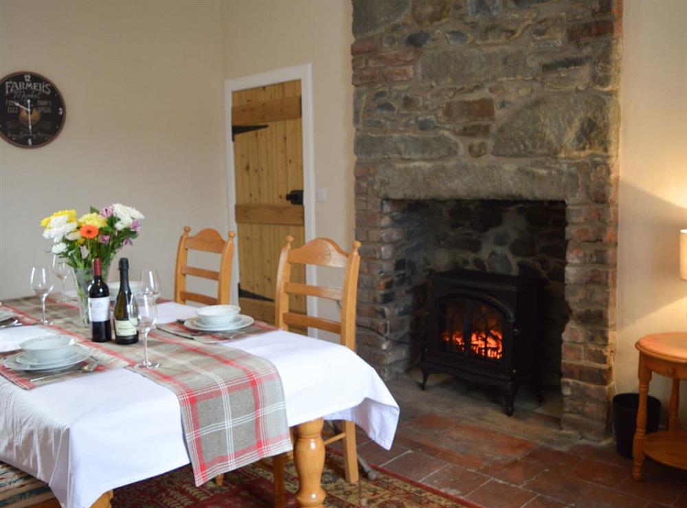 Dining room with wood burner at The Dairy House in Newton Stewart, near Wigtown, Wigtownshire