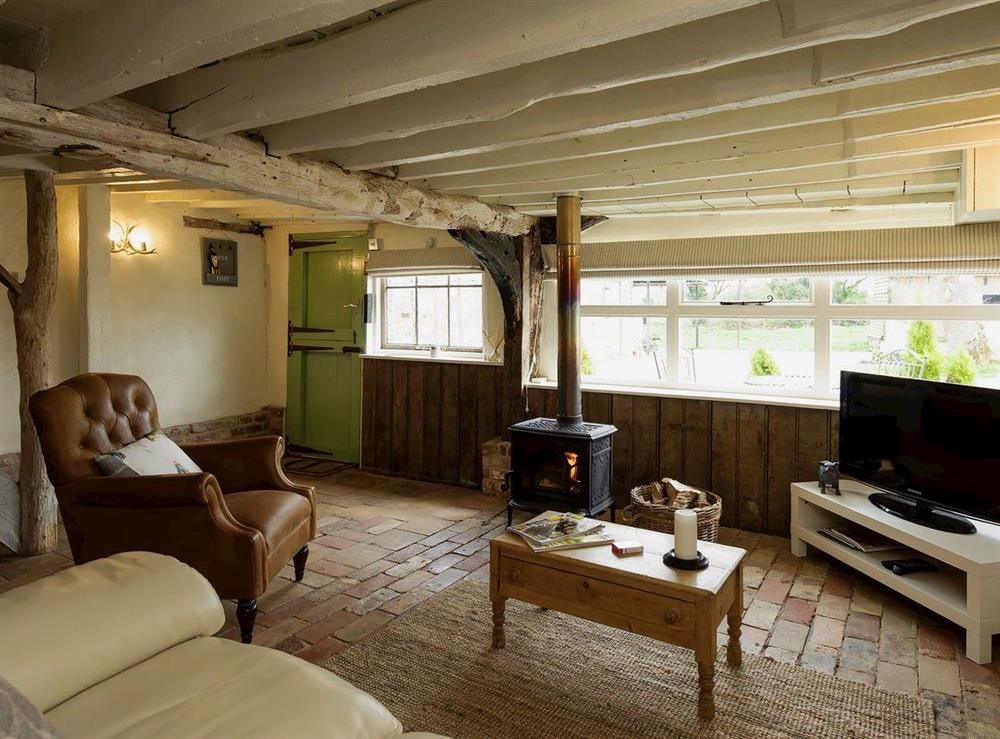 Comfy living area with wood burner at The Dairy in Ubbeston, near Halesworth, Suffolk, England