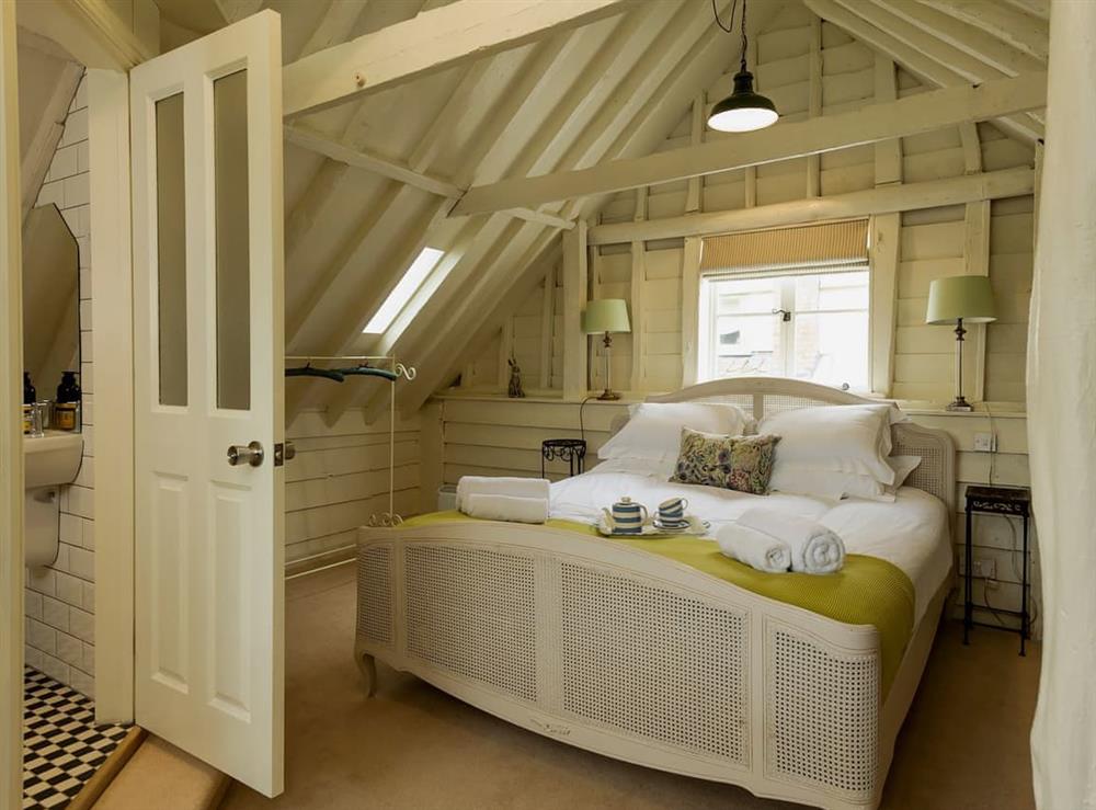 Relaxing bedroom with super kingsize bed and en-suite at The Dairy in Ubbeston, near Halesworth, Suffolk, England