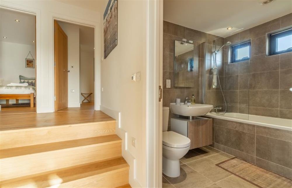 The Deck House, St Agnes. Family bathroom with shower over bath, wash basin and WC at The Deck House, Chapel Porth, St Agnes