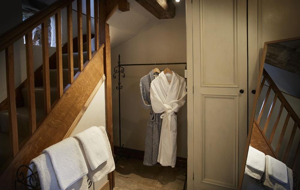 A staircase from the first floor descends to a ground floor dressing room area at The Dovecote, Pauntley