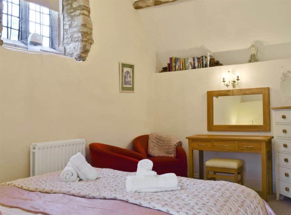Comfortable double bedroom with seating area at The Dovecote in Thrupp, Kidlington, Oxfordshire., Great Britain