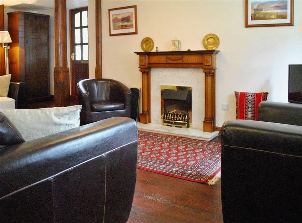 Delightful wood floored living room with feature fireplace at The Dovery in Sedbergh, Cumbria