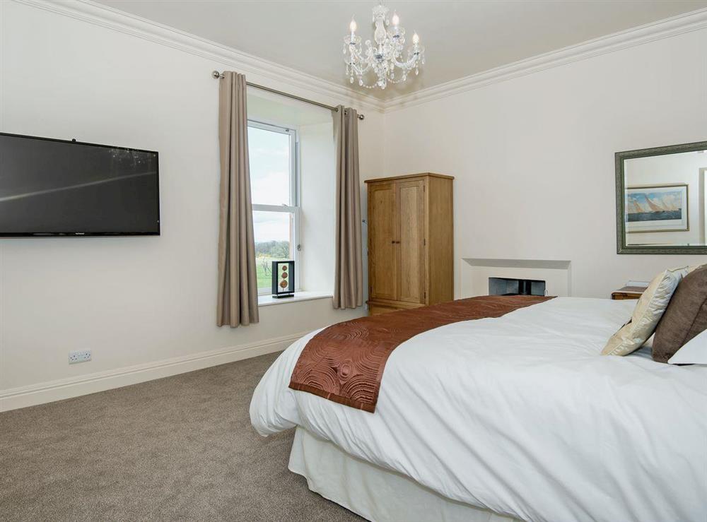 Spacious double bedroom with cosy woodburner and TV (photo 2) at The Duchy in Kirkcudbright, Kirkcudbrightshire