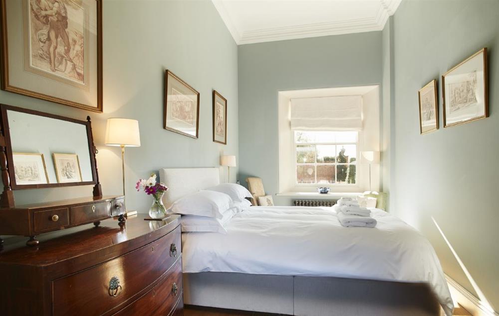 Bedroom on the ground floor with a 5’ king-size bed and views to the south at The East Wing, Aylsham near Norwich