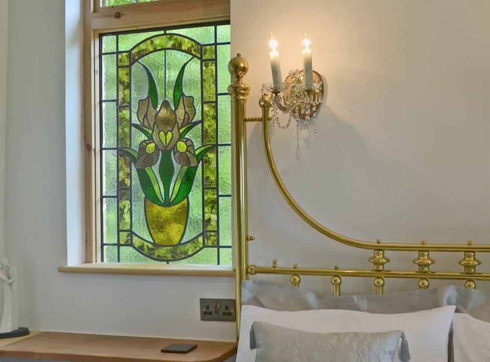 Beautiful stained glass window in double bedroom at The Escape in South Hill, near Callington, Cornwall