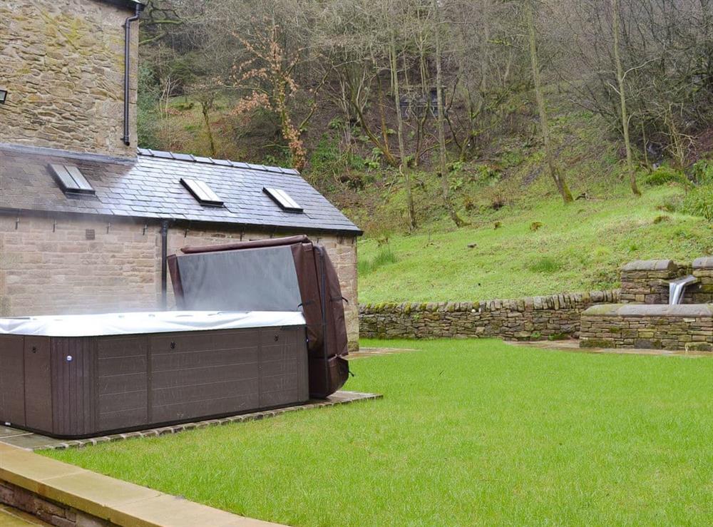 Garden and grounds complete with hot tub at The Farmhouse at Gradbach in Buxton, Staffordshire